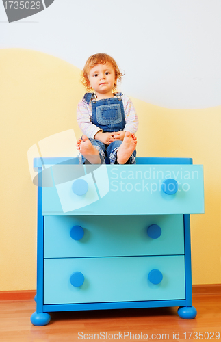 Image of Kid sitting on the cabinet