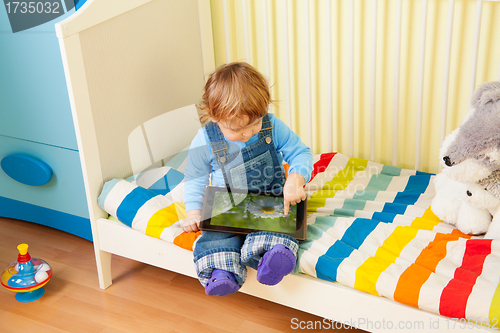 Image of Kid playing with tablet pc