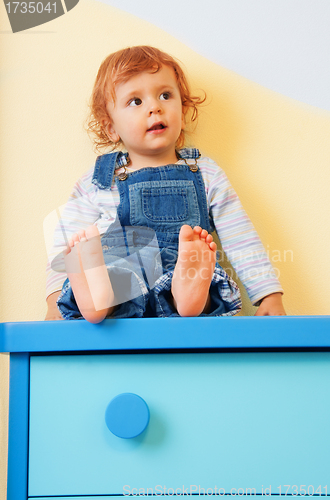 Image of kid sitting on furniture