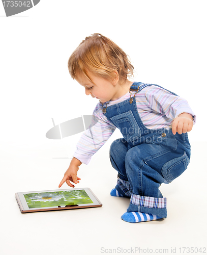 Image of Young toddler touching tablet pc