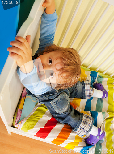 Image of Happy kid hands on bed