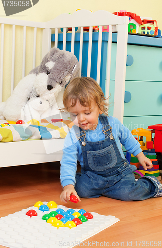 Image of Smart little boy playing with mosaic