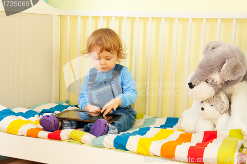 Image of Boy playing with tablet pc