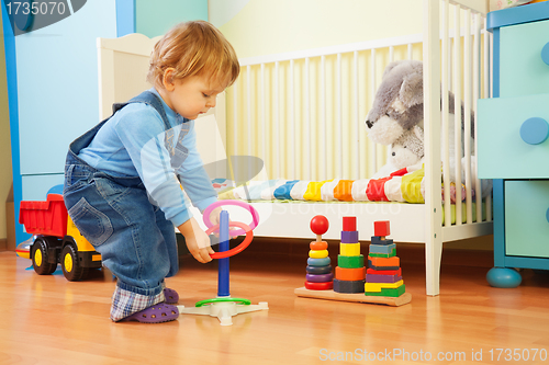 Image of Boy playing with stacking rings