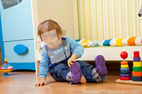 Image of Baby putting on sandal