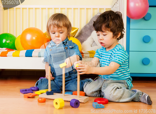 Image of Two boys playing with pyramid blocks