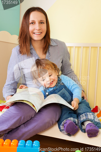 Image of Mother and toddler reading a book