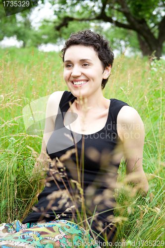 Image of girl resting on fresh spring grass 