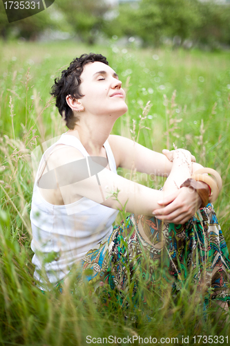 Image of girl resting on fresh spring grass 