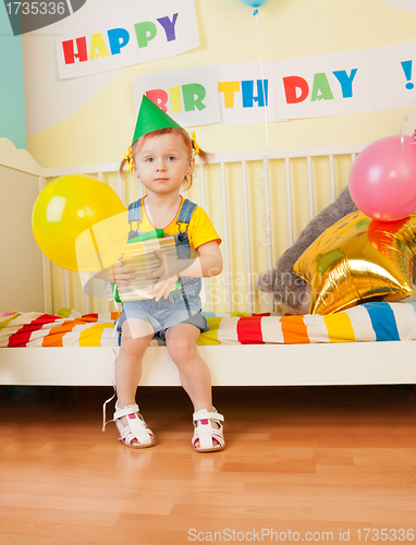 Image of Little girl with present and baloon