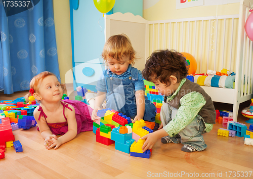 Image of Kids playing with plastic blocks