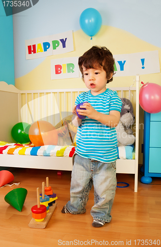 Image of Asian kid playing with toys
