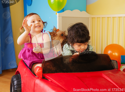 Image of Kids with dog in the car