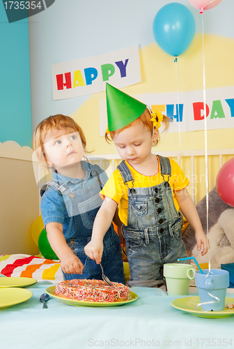 Image of Two kids eating cake on the birthday party