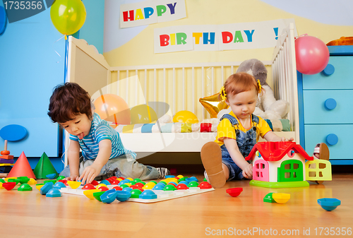 Image of boy and girl playing with mosaic