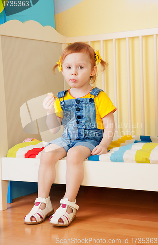 Image of Little girl eat some snacks