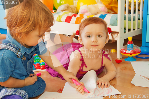 Image of Boy and girl drawing with crayons