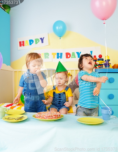 Image of Three kids eating birthday cake