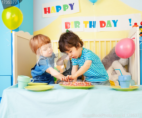 Image of Two kids eating birthday cake