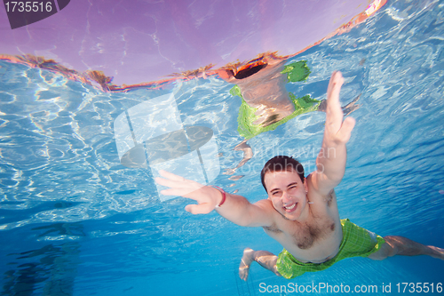 Image of Happy man diving underwater