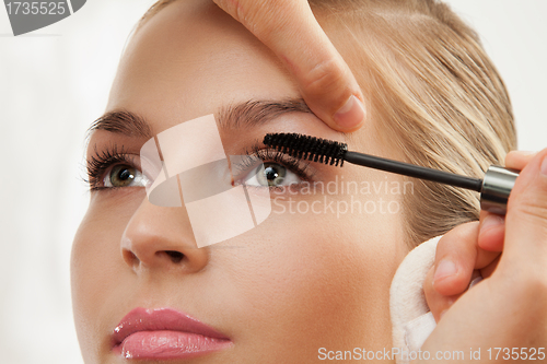Image of separating and curling lashes with mascara brush