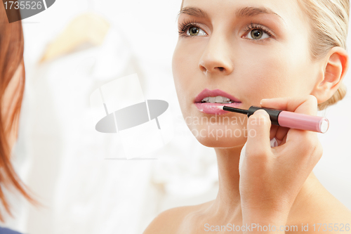 Image of Applying pink lipglass