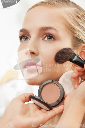 Image of Makeup artist apply blush on cheeks