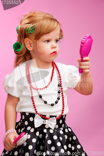 Image of Little girl playing a hairdresser