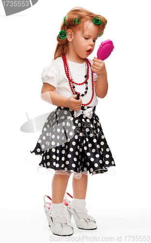 Image of Little girl playing with makeup