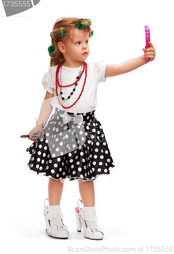 Image of Little girl playing with mothers toys