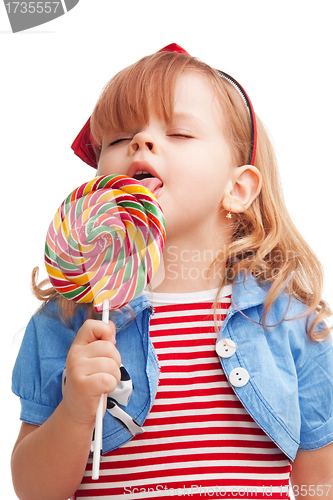 Image of Little girl licking big lollipop