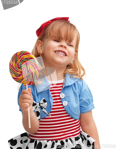 Image of Happy girl smiling and holding lollipop