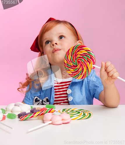 Image of Thoughtful girl with lollipop