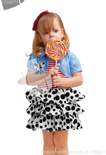 Image of Small girl standing with lollipop