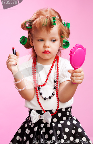 Image of Little beautiful girl playing to be a big sister