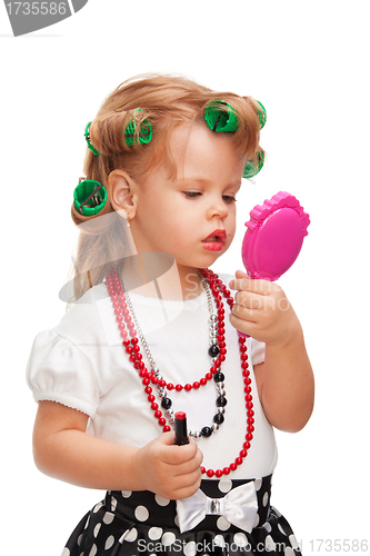 Image of Little girl making up her face