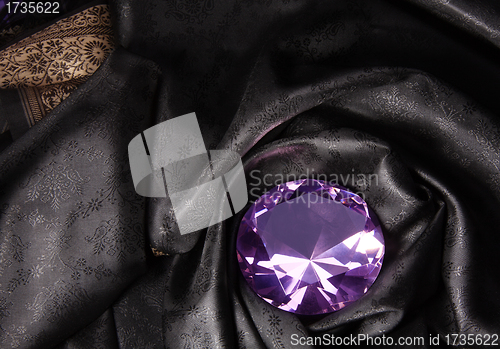 Image of Pink diamond in the black fabric