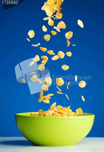 Image of Corn flakes falling to the bowl for breakfast