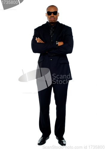 Image of African corporate man standing with crossed arms