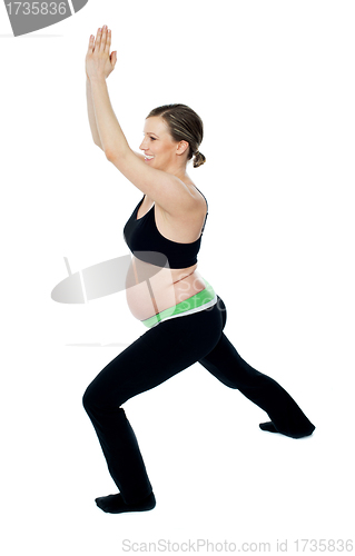 Image of Healthy pregnant woman doing gymnastics