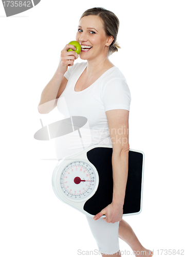 Image of Young pregnant woman enjoy fresh green apple