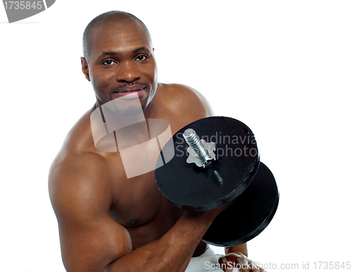 Image of Powerful young man lifting weights