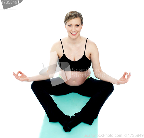 Image of Beautiful pregnant woman in lotus pose
