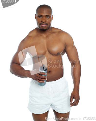 Image of Athlete posing with health drink bottle