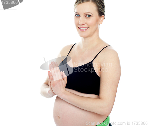 Image of Gorgeous pregnant woman doing yoga