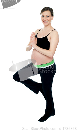 Image of Beautiful pregnant woman doing yoga