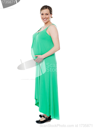 Image of Pregnant woman posing in trendy fashion wear