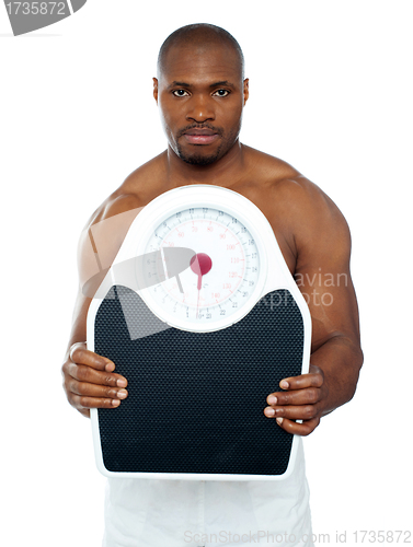 Image of Attractive athlete showing weighing scale