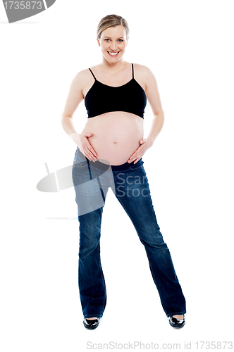 Image of Pregnant woman wearing fashionable outfit