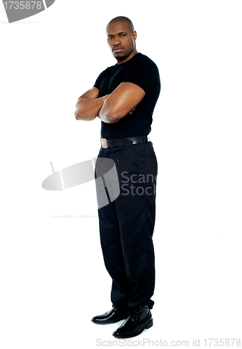 Image of Male security guard with strong arms crossed
